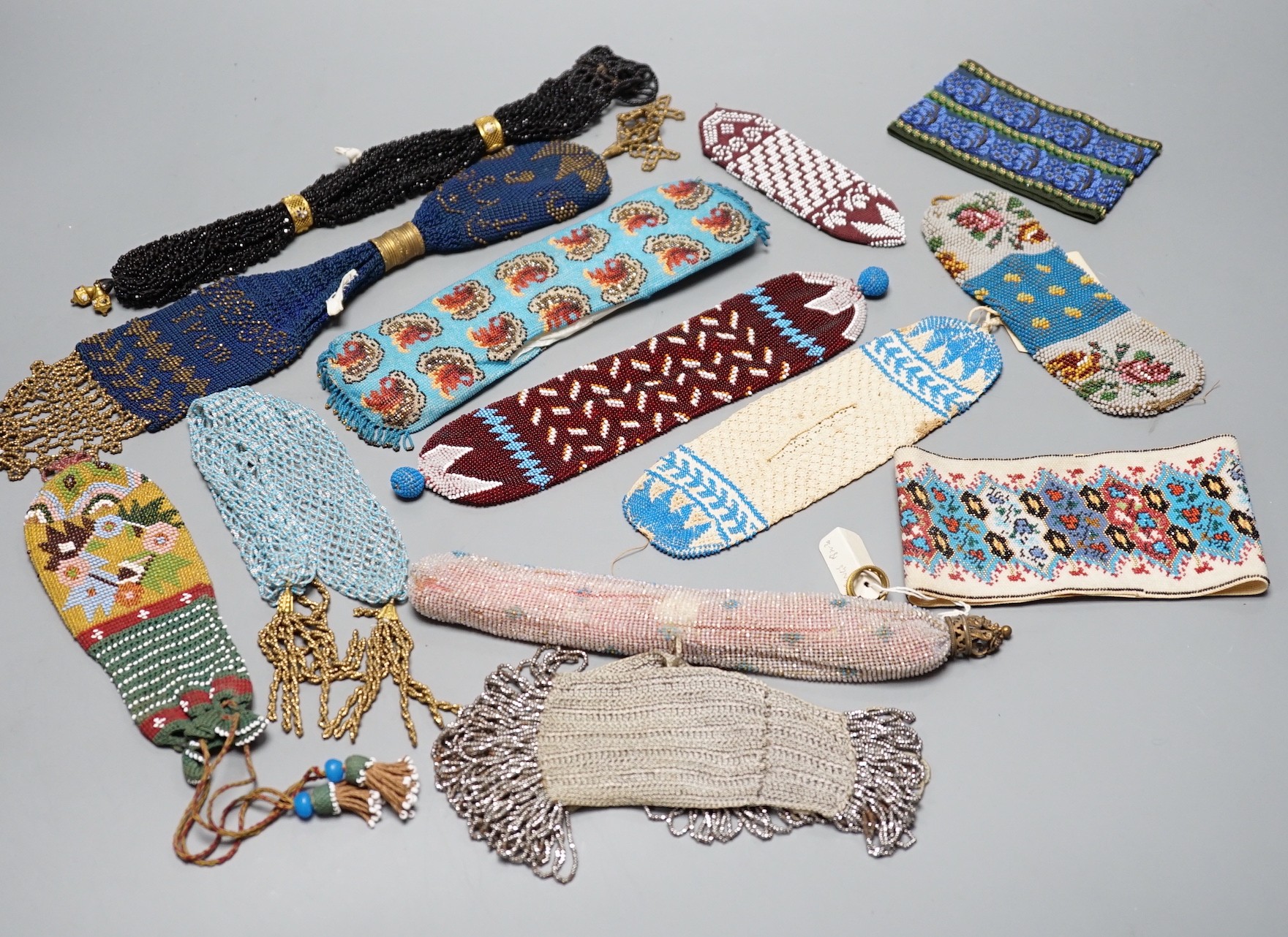 A collection of nine Berlin beadwork miser's purses and three panels, longest 26cm